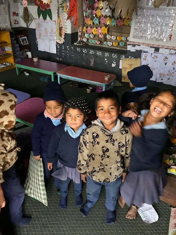 A group of young and cheeky Nepali students in school room