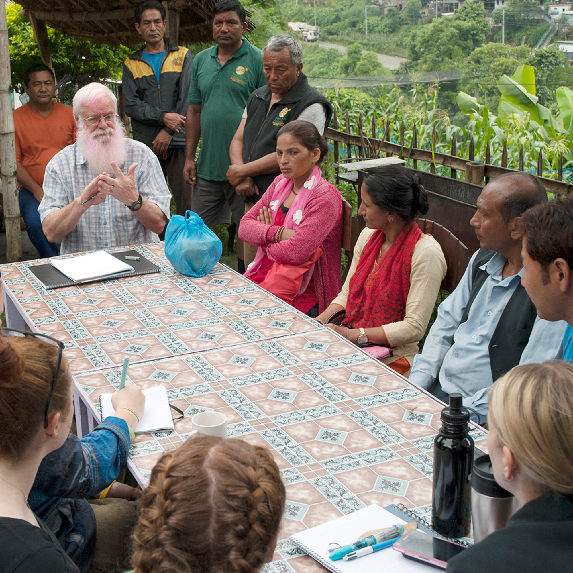 Group of village elders and volunteers consulting on project idea